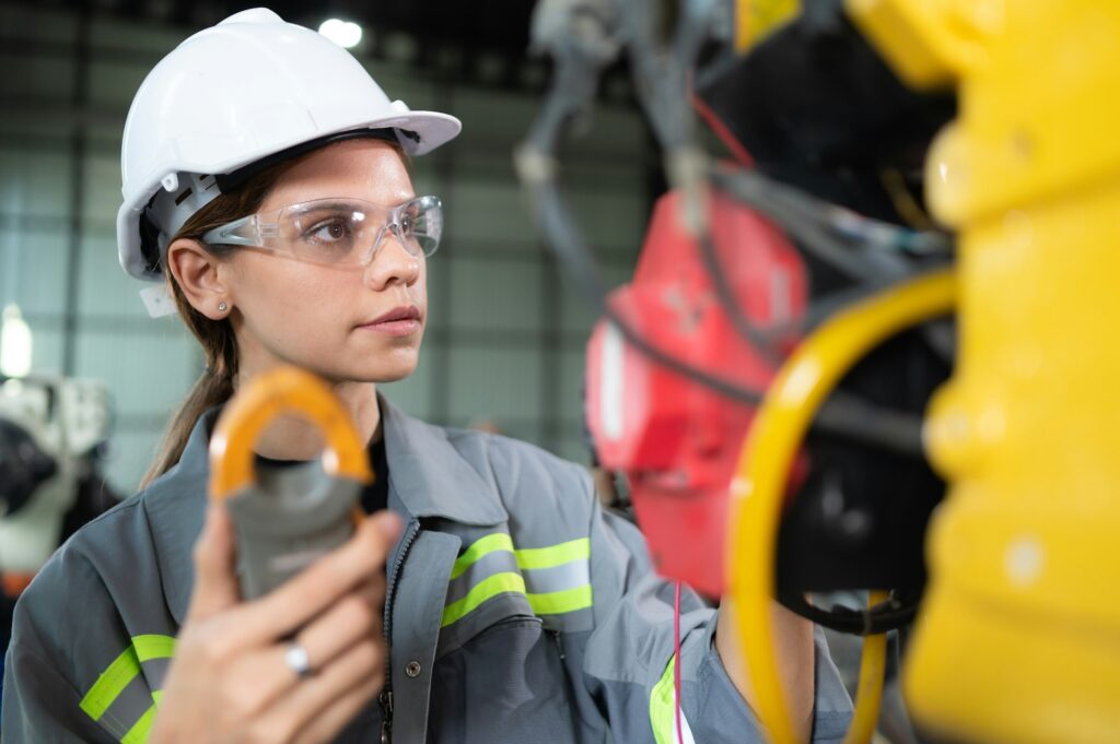 a-female-engineer-inspects-the-electrical-system-of-every-robotics-arm-