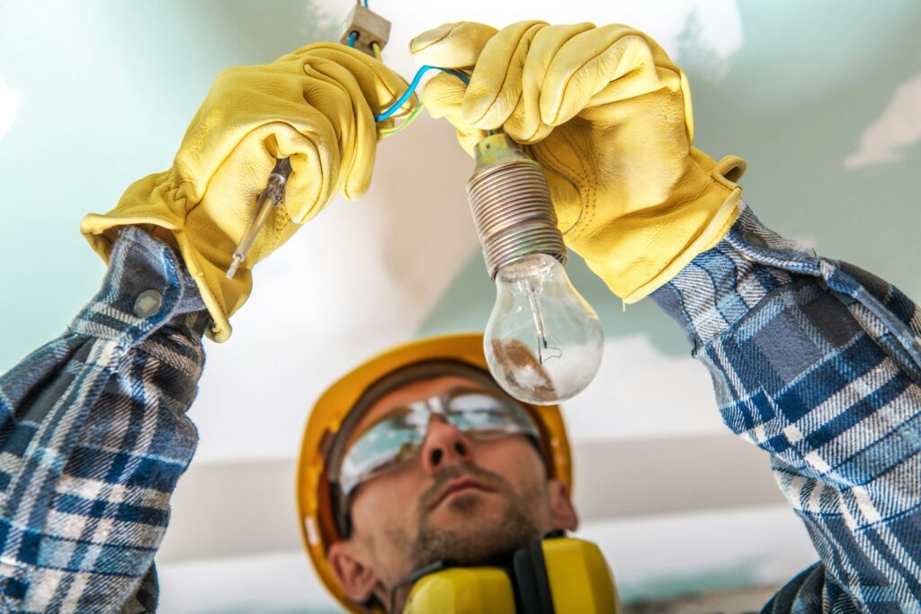 electrician-checking-cables-in-a-lighting-system-to-fix-a-bug