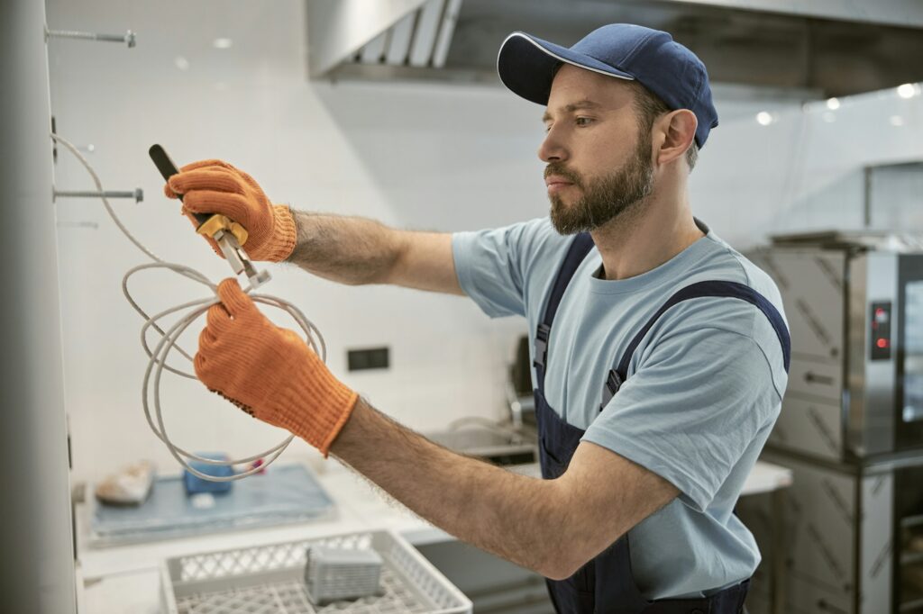 male-electrician-repairing-electric-cable-with-pliers